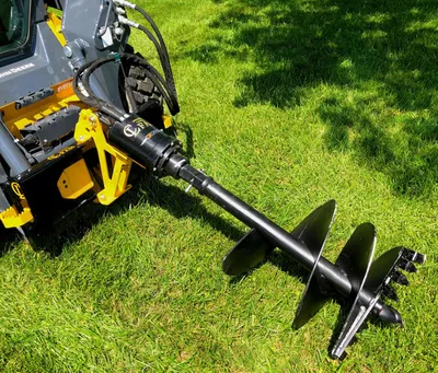 CL Fabrication auger drive on a skid steer drilling in a yard