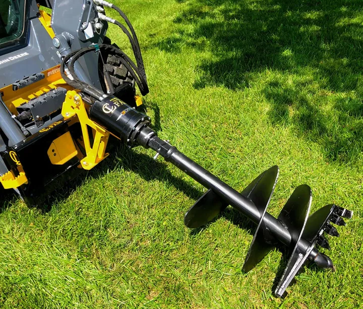 CL Fabrication auger drive on a skid steer drilling in a yard