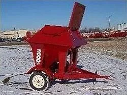 Red 1.5 ton portable bulk bin with auger on a trailer frame