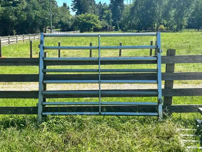 Galvanized 8-foot sweep panel in front of a wood fence