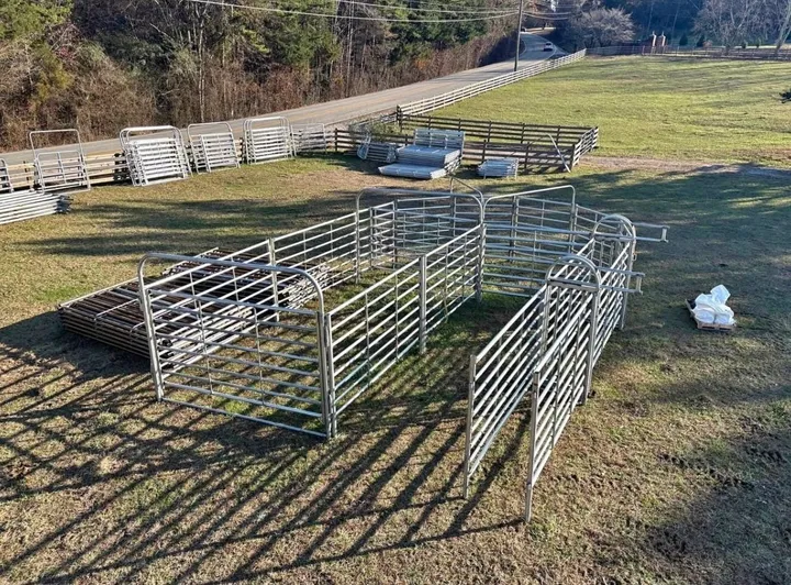 Lockler cattle handling system: 180-degree sweep tub, alley and holding pen in a field