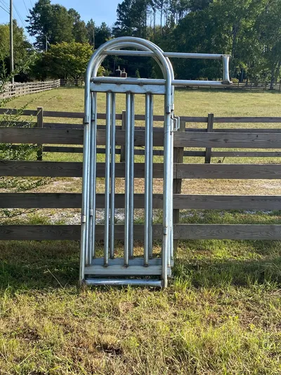 Galvanized alley slide gate in its frame, standing upright