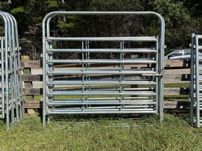 Galvanized 8-foot heavy bow gate against a wood fence