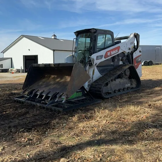 94-inch B-Built Rake-N-Ator on a compact track loader in a field