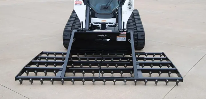 Rake-N-Ator on a track loader, front view