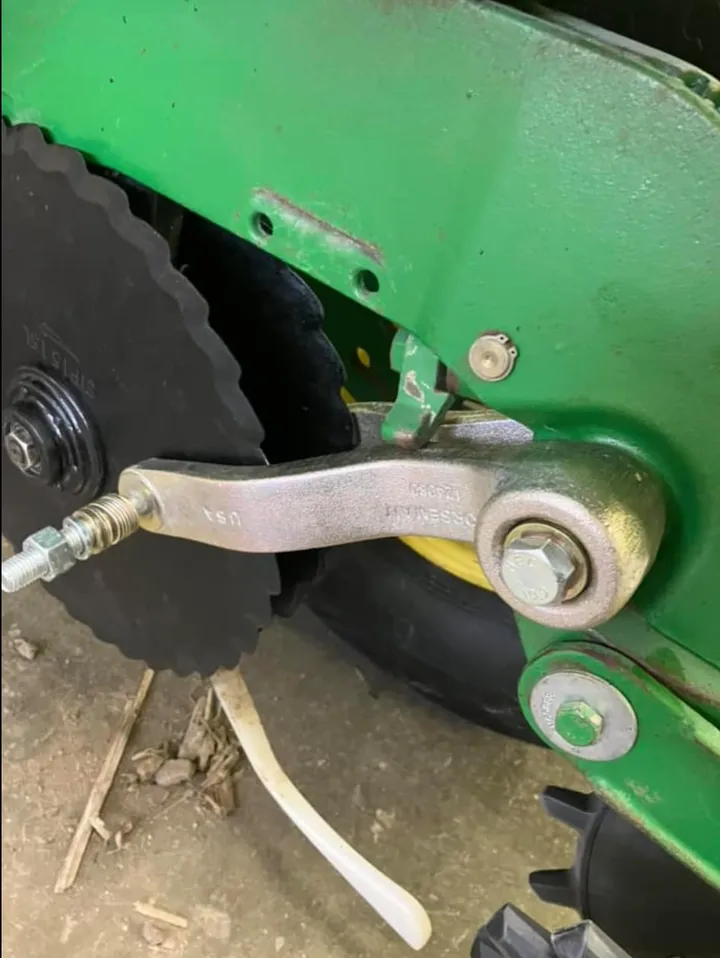 Norseman gauge wheel arm installed on a John Deere planter row unit