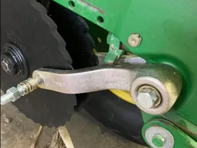 Norseman gauge wheel arm on a John Deere planter row unit